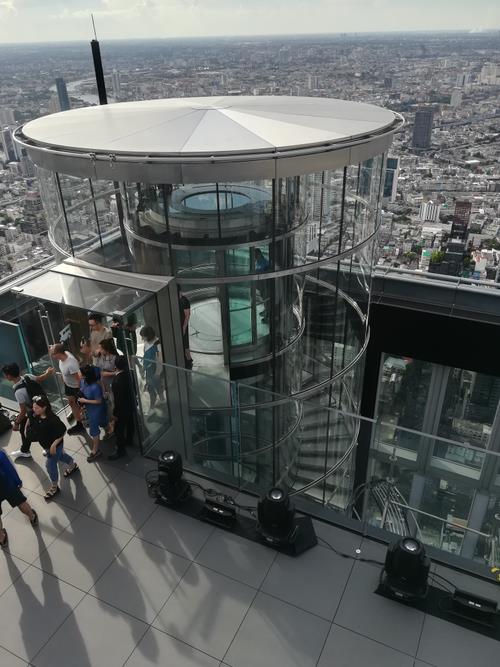 The glass elevator with a spiral staircase